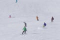 Skiers and snowboarders going down the slope Royalty Free Stock Photo