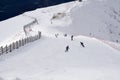 Skiers and snowboarders going down the slope Royalty Free Stock Photo