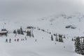 Skiers and snowboarders going down slopes of Whistler Blackcomb