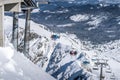 Skiers and snowboarders going up the ski slopes on a ski lift Royalty Free Stock Photo