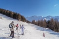 Skiers and snowboarders in mountains ski slopes of resort Les Arcs, France.