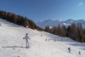 Skiers and snowboarders in mountains ski slopes of resort Les Arcs, France.