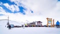 Skiers, snowboarders relaxing near mountain hut, Alps, Livigno, Italy