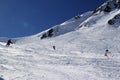 Skiers and snowboarders riding on a ski slope in mountain resort snowy winter, ski resort Rosa Khutor Royalty Free Stock Photo