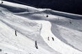 Skiers and snowboarders riding on a ski slope in mountain resort snowy winter Royalty Free Stock Photo