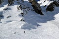 Skiers and snowboarders riding on a ski slope in mountain resort snowy winter, ski resort Rosa Khutor Royalty Free Stock Photo