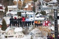 Skiers and snowboarders are sitting on a ski cable chair lift