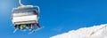 skiers and snowboarders in a ski lift against clear blue sky Royalty Free Stock Photo