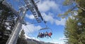 Skiers and snowboarders on a ski lift, cinematic shot