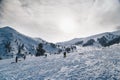 Skiers at snowy ski slope enjoying winter holidays at Kalavryta ski Resort in Greece.