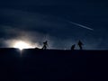 Skiers with sun in the background. Extreme weather on slope for down hill skiing. Royalty Free Stock Photo