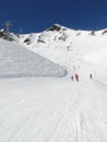 Skiers take the piste down to a ski resort