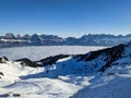 Skiing above the sea of fog. Enjoy the sun and the beautiful weather in the Alps.View of the Churfirsten and Tannenboden