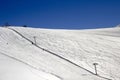 Fog and chair lifts on a mountainskiing facility and the traces on ground