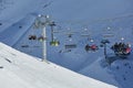 Skiing slopes with ski lift, skiers ascending Royalty Free Stock Photo