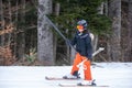 Skiing in the snow. One Asian girl sitting on ski lift by grabbing the rope and holding ski sticks. Vacation in Switzerland Royalty Free Stock Photo