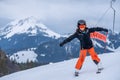 Skiing in the snow. One Asian girl sitting on ski lift by grabbing the rope and holding ski sticks. Vacation in Switzerland Royalty Free Stock Photo