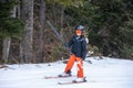 Skiing in the snow. One Asian girl sitting on ski lift by grabbing the rope and holding ski sticks. Vacation in Switzerland Royalty Free Stock Photo