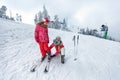 Skiing, winter fun-Mother preparing for skiing daughter Royalty Free Stock Photo