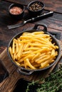 Skilet full of Potato french fries with salt. Wooden background. Top view Royalty Free Stock Photo