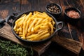 Skilet full of Potato french fries with salt. Wooden background. Top view Royalty Free Stock Photo