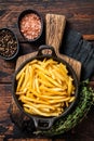 Skilet full of Potato french fries with salt. Wooden background. Top view Royalty Free Stock Photo