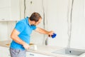 Skilful husband cleaning after self kitchen renovation