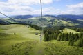 Skilift carrying tourists to summer alpine meadows