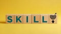 Skill Development Concept, Wooden Blocks, Target Arrow, Yellow Background with Copy Space Royalty Free Stock Photo