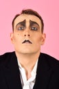 Skill at improvisation. Mime artist. Mime with face paint. Man with mime makeup. Theatre actor miming. Stage actor