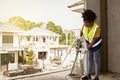 African American female construction worker working on a housing project under construction.