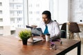 Skilled African American male doctor wearing surgeon medic suit studying history disease of patient