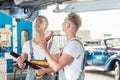 Skilled auto mechanic replacing the shock absorbers of a car