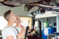 Skilled auto mechanic replacing the shock absorbers of a car