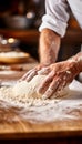 Skilled baker kneading dough in bakery with blurred background, perfect for text placement.