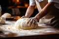 Skilled baker kneading dough for fresh bread in bakery with blurred background and copy space