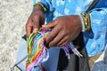 Colorful string in black man`s hands