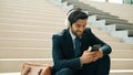 Skilled business man listening and enjoy music while wear headphone. Exultant. Royalty Free Stock Photo