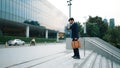 Skilled business man walking up stair while holding bag in the hand. Exultant. Royalty Free Stock Photo