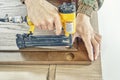 Skilled carpenter assembles wooden door fixing glazing bead