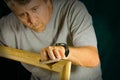 Skilled carpenter man sanding wood frame Royalty Free Stock Photo