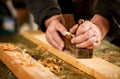 Skilled carpenter using a handheld plane Royalty Free Stock Photo