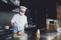 Chef  with protective coronavirus face mask preparing pizza Royalty Free Stock Photo