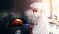 Chef  with protective coronavirus face mask preparing pizza Royalty Free Stock Photo