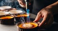 Culinary artistry: Hands caramelizing creme brulee with kitchen torch Royalty Free Stock Photo