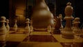 Skilled chessman hand moves white bishop on chessboard