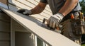Skilled Contractor Installing Vinyl Siding & Window Trim with Precision Tools Royalty Free Stock Photo
