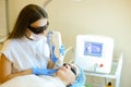 Skilled cosmetologist removing permanent makeup with laser for young girl.