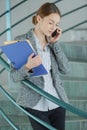 Skilled female worker using cell telephone