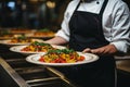 Skilled food stylist artfully perfecting a delicious dish in a modern restaurant setting.